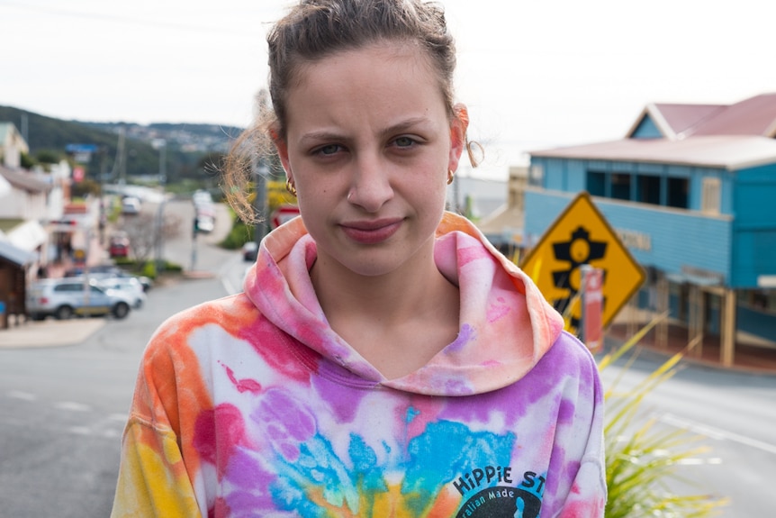 Teenage girl standing in the middle of the street in Narooma