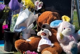 Toys, flowers and notes are left outside a home in Tootgaroot.