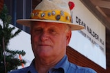 Peter Martin stands in front of the Christmas tree outside Dean Nalder's office.