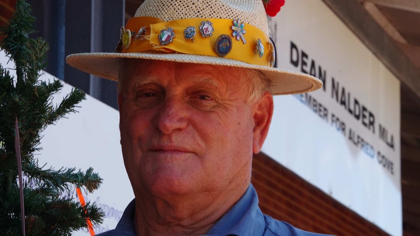 Peter Martin stands in front of the Christmas tree outside Dean Nalder's office.