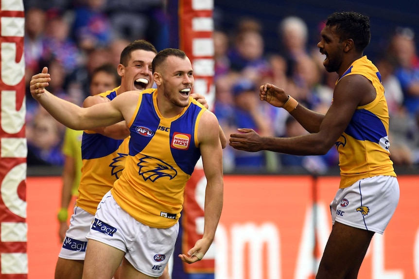 Daniel Venables of the Eagles (2nd L) reacts after kicking a goal against the Bulldogs.