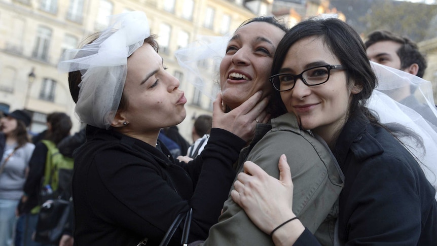 Women celebrate after same-sex marriage bill passes French National Assembly