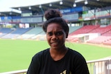 Portrait of Julie Kerinauia with football stadium in background