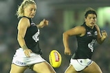 Tayla Harris watches the ball onto her boot as Maddy Prespakis runs behind her.
