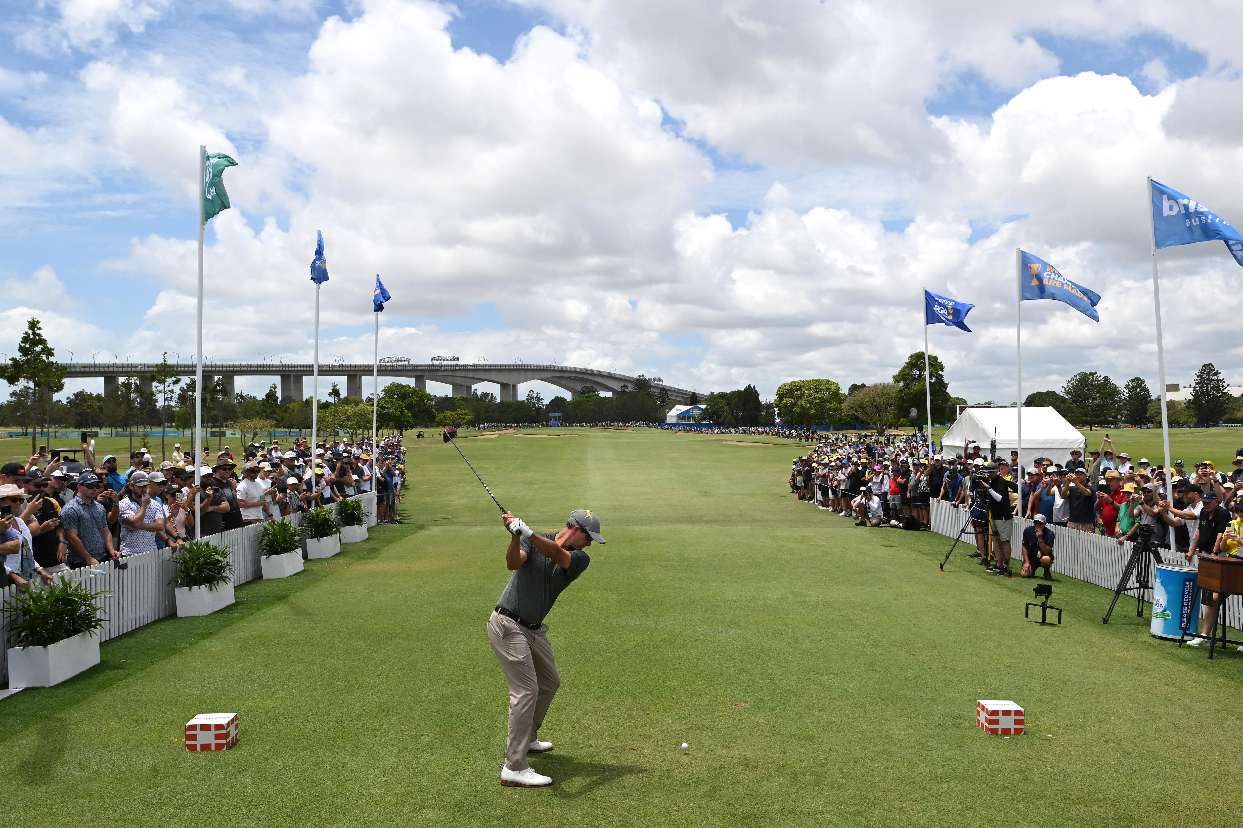 Adam Scott pulls the club back and prepares to hit it as the gallery looks on