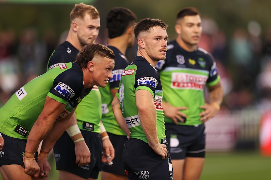 A group of NRL players look despondent 