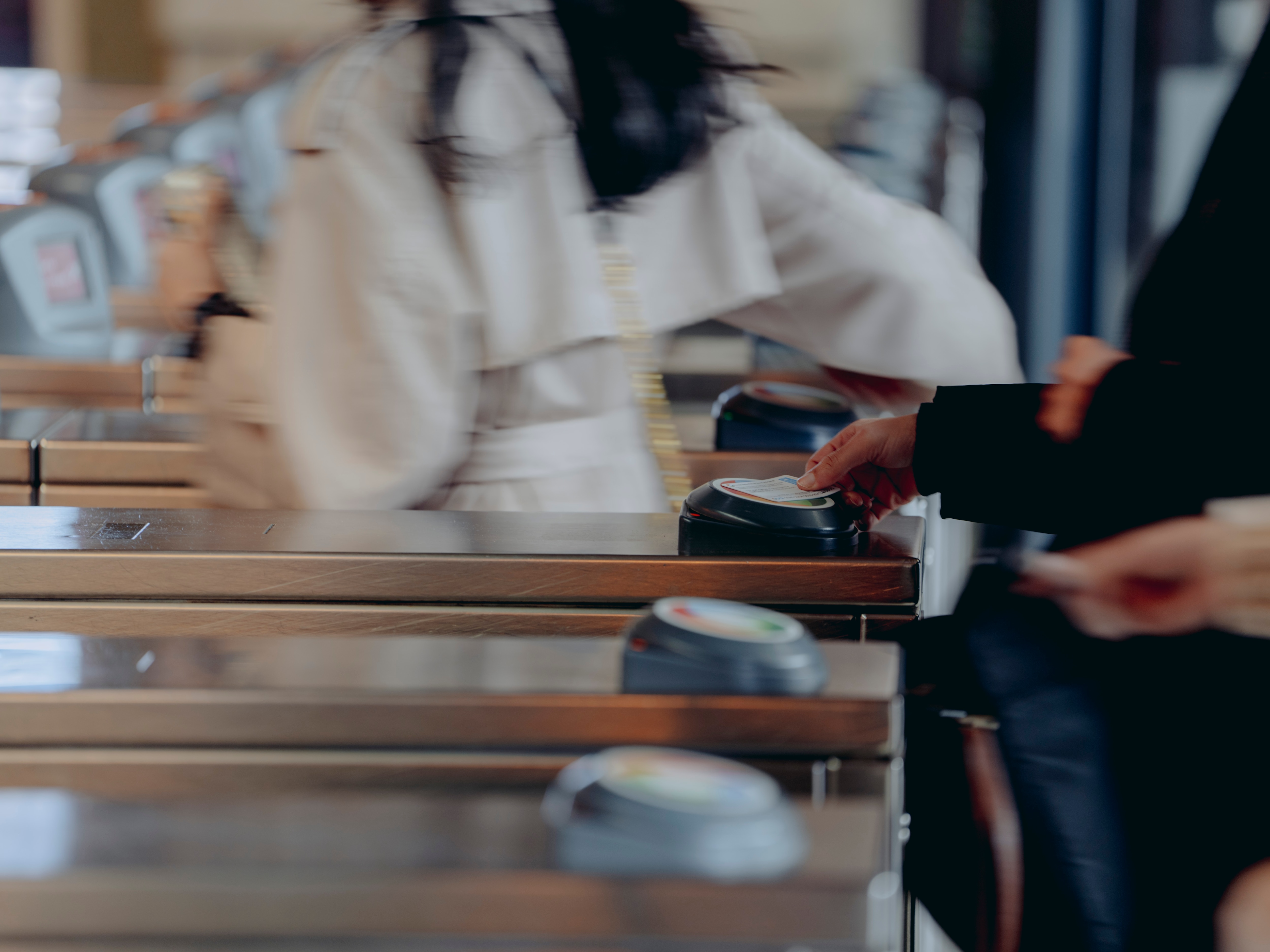 Train commuters at Sydney's Central Station walk through the Opal machines