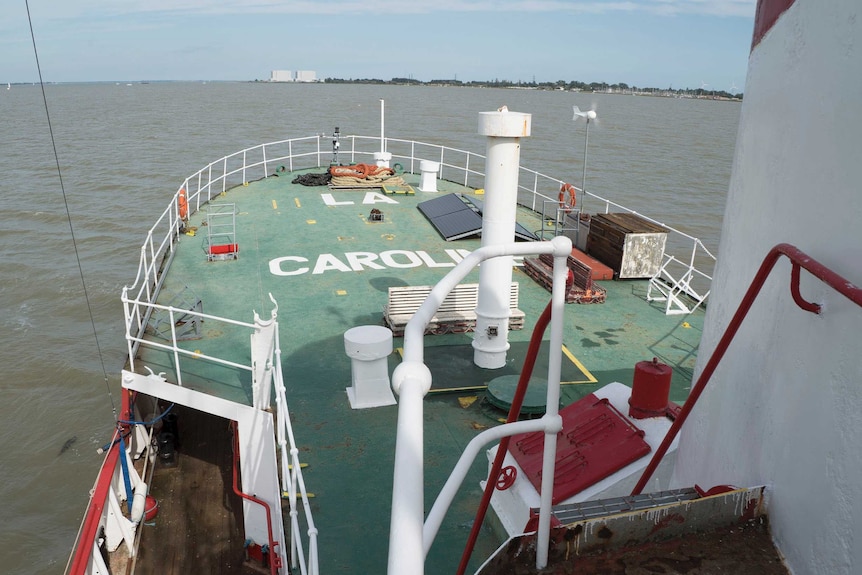 Front a ship with shore in the background