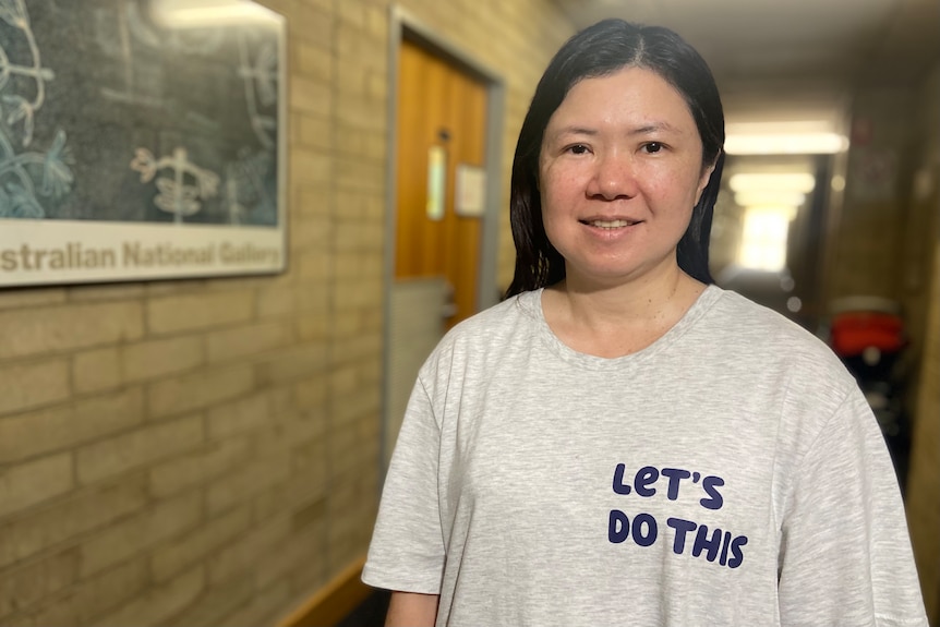 A woman wearing a shirt that reads 'let's do this'
