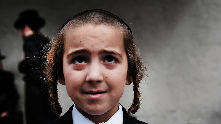 A young boy from the Orthodox Jewish community in Brooklyn wearing side curls, as is the religious tradition.