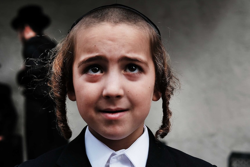 A young boy from the Orthodox Jewish community in Brooklyn wearing side curls, as is the religious tradition.