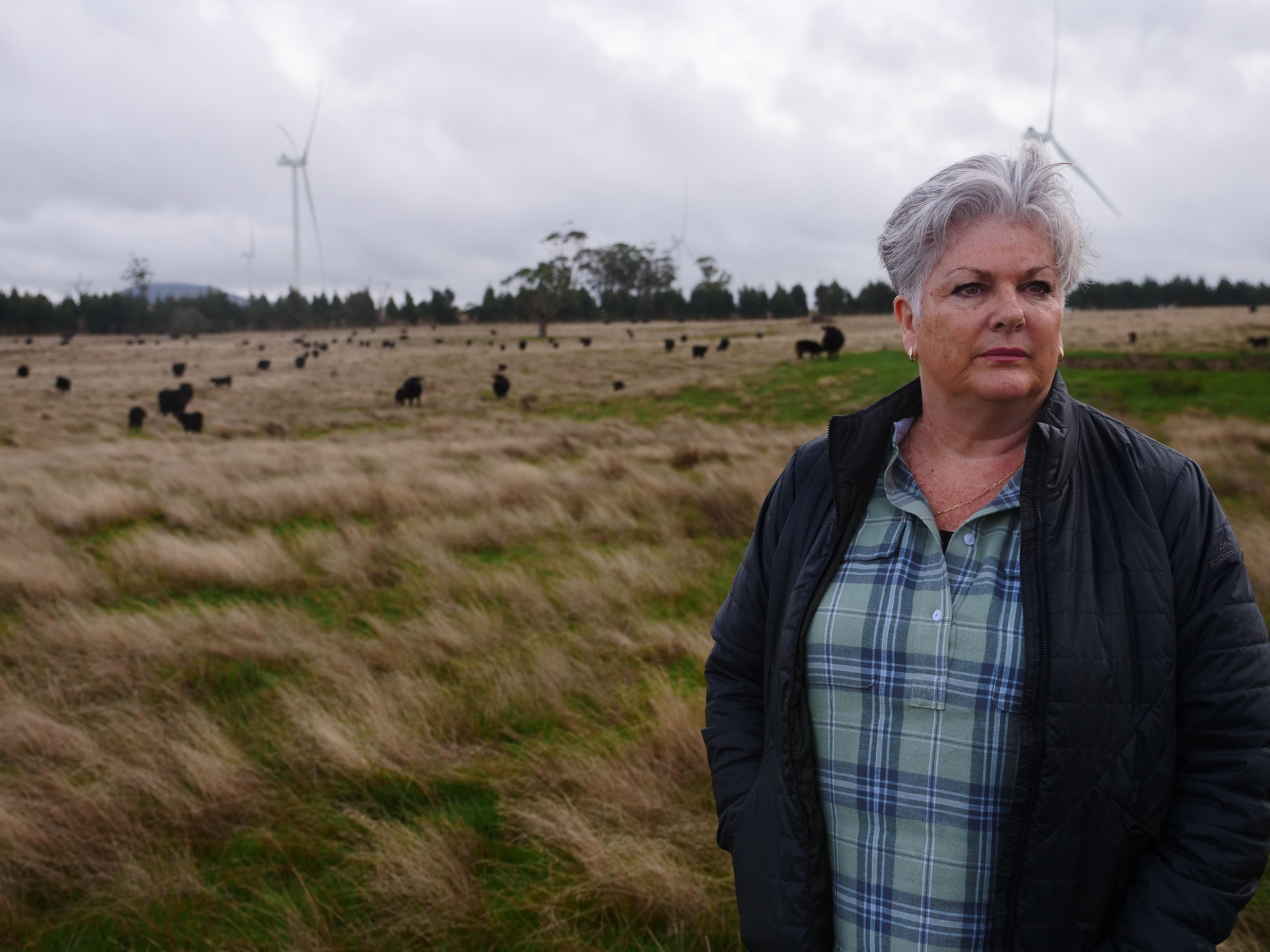 A woman poses on a farm