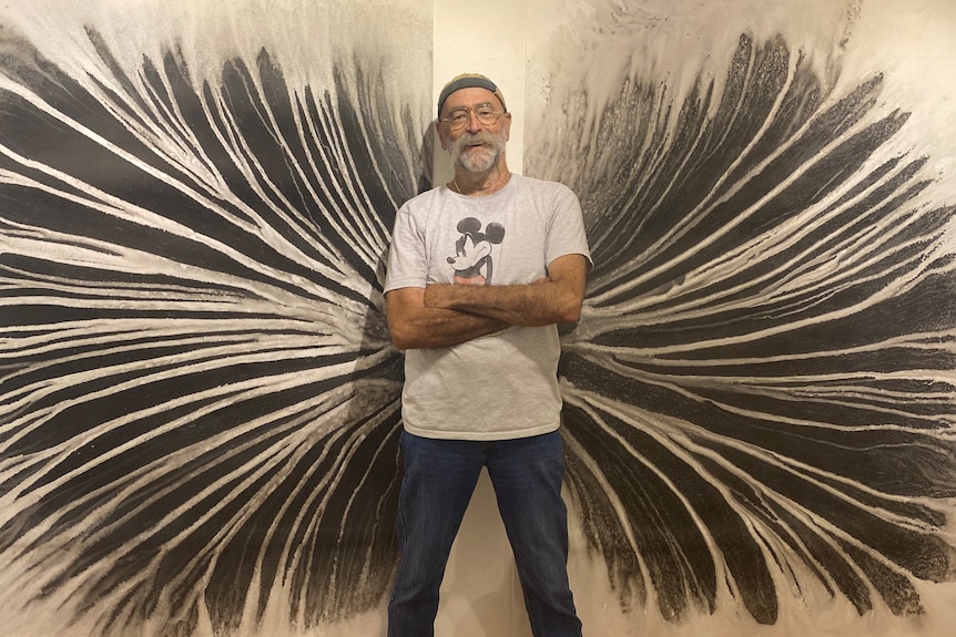 Franc stands in front of one of his massive, wall-covering ink artworks.