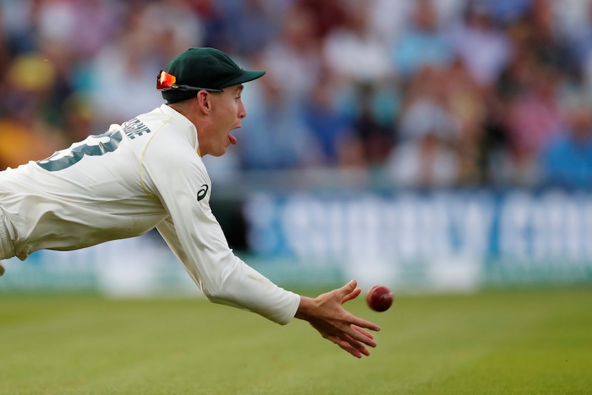 Marnus Labuschagne catches the ball to dismiss England's Jos Buttler.
