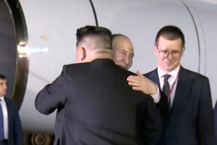 Vladimir Putin hugging Kim Jong Un. 