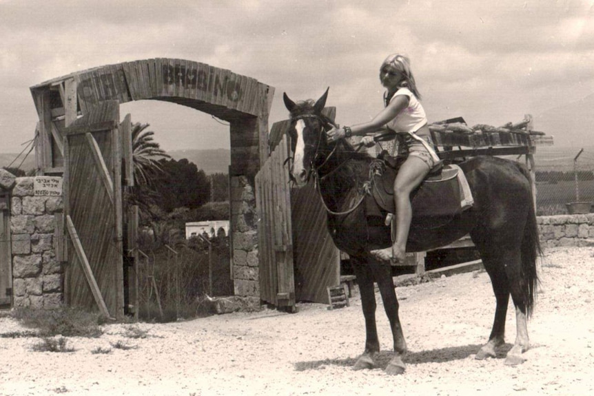 Rina Avivi seen in the 1970s riding her horse near the museum.