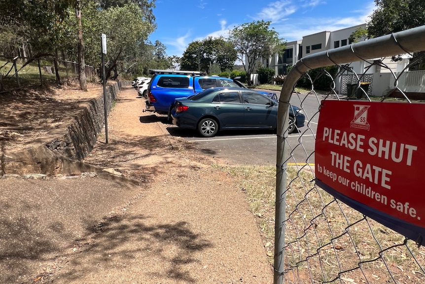 A sign saying 'please close gate' and a makeshift footpath