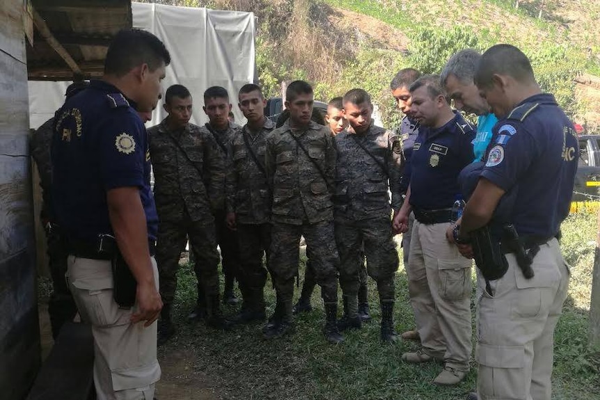 Search and rescue officers stand in a group