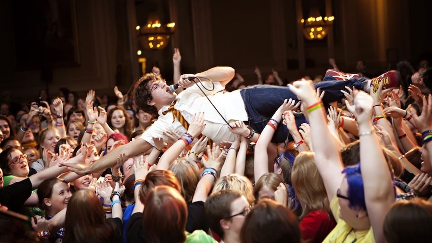 Wizard rock band Harry and the Potters crowd surf.