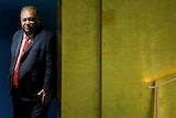 Baron Waqa stands behind a yellow wall, waiting to take the stage at a UN conference in New York