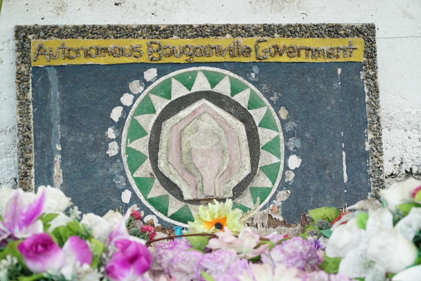 The words 'Autonomous Bougainville Government' are spelled out with tiny stones.