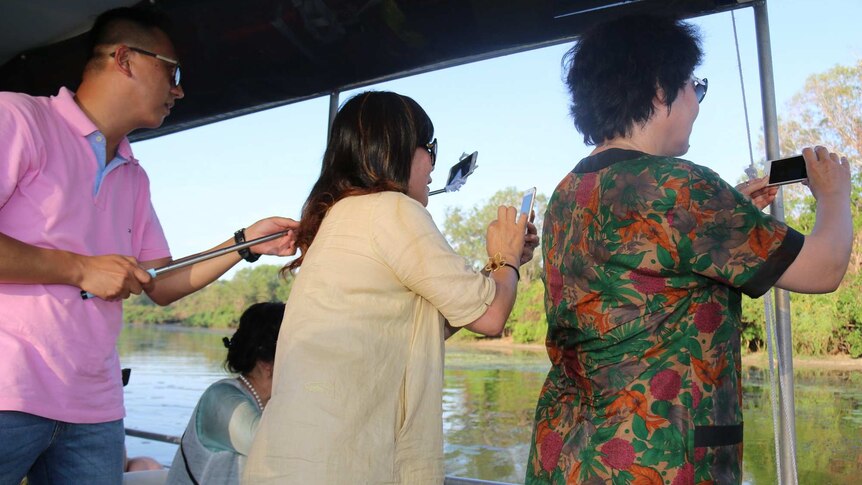 Chinese tourists on a crocodile cruise in NT