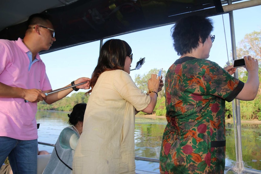 Chinese tourists on a crocodile cruise in NT