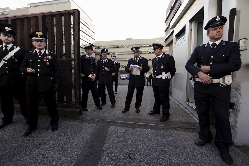 Police stand outside Rome's criminal court.