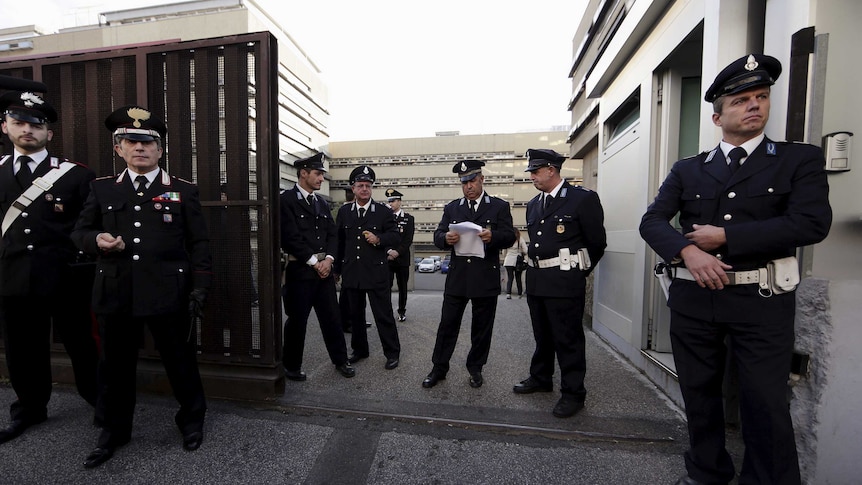 Police stand outside Rome's criminal court.