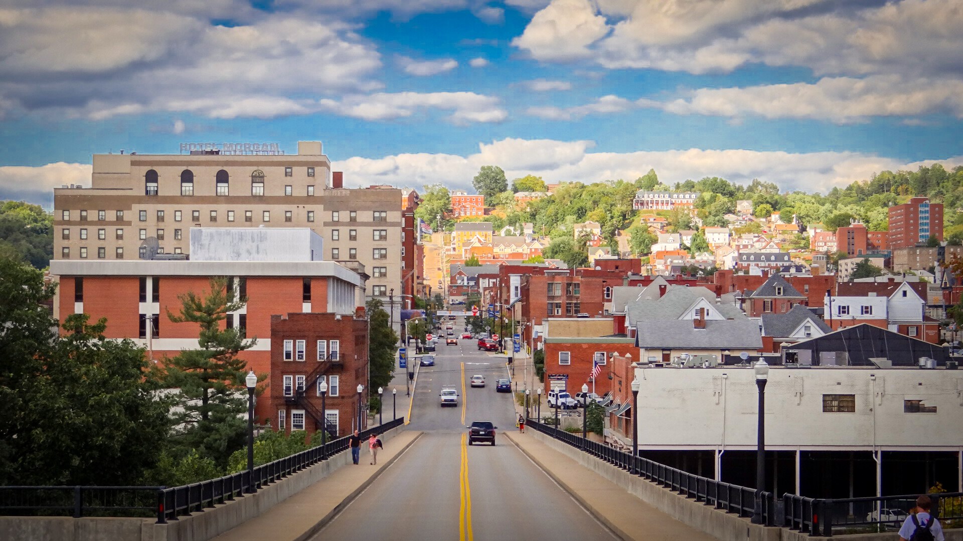 A road running through a small, historic US town under a blue sky