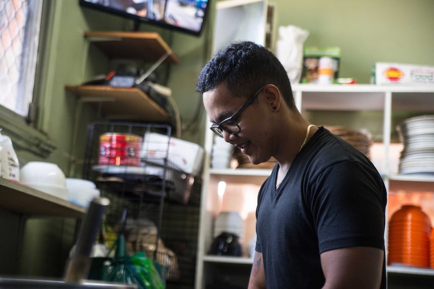 Amye's son Juan helps her in her restaurant kitchen.