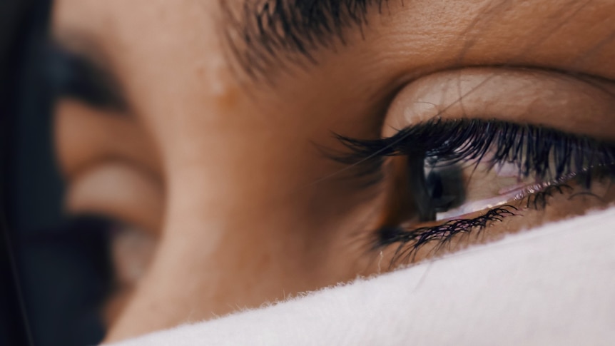 Close up of a woman's eyes brimming with tears.