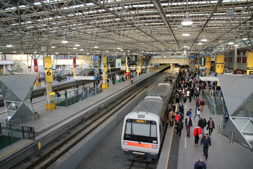 A train station with a moderate amount of commuters present