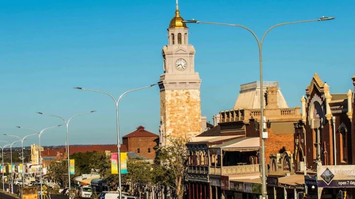 A tall bell tower with a golden cap