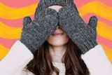 Woman in winter clothes covering her eyes for a story about how to keep warm in winter with heating