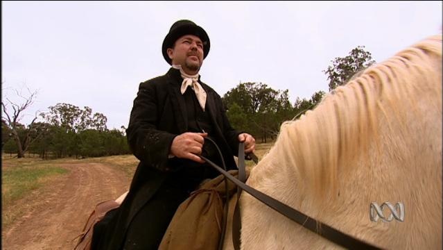 Man in period costume rides horse