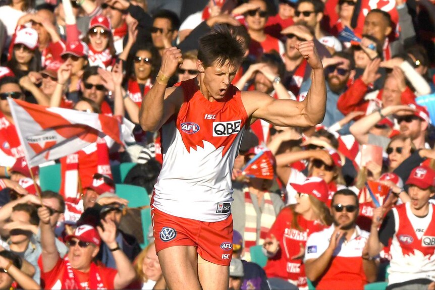 Callum Sinclair pumps both fists as the crowd celebrates behind him.