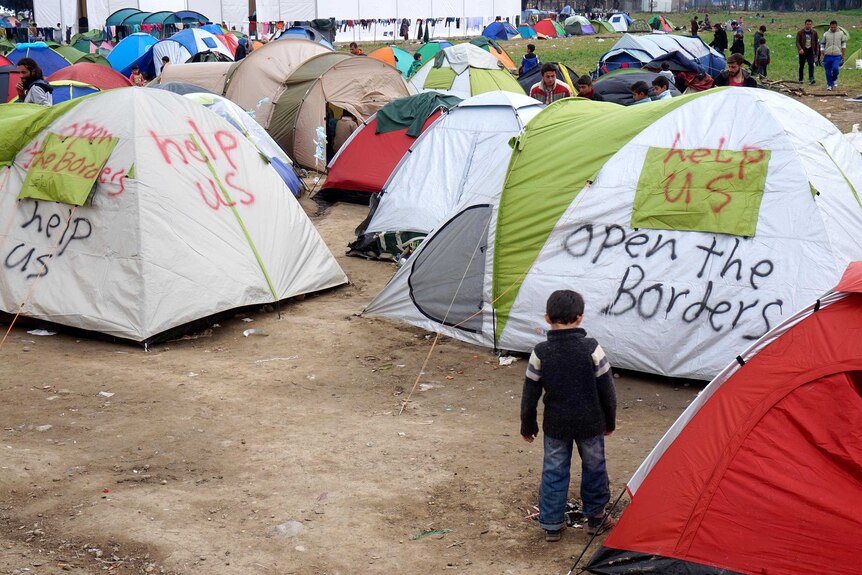 A child plays among tents in the Idomeni refugee camp.