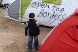 A child plays among tents in the Idomeni refugee camp.