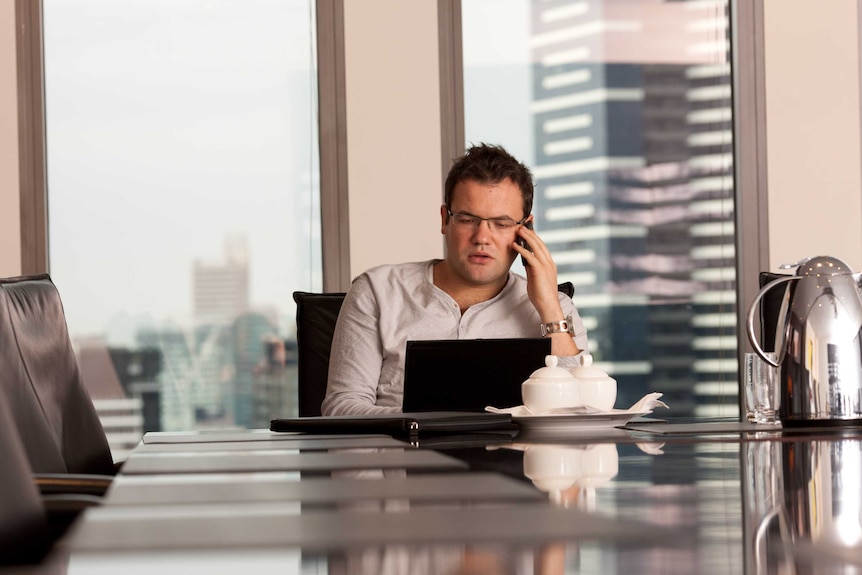 Ruslan Kogan on the phone in a city office.