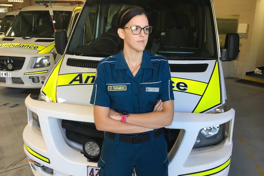 Tash Adams standing in front of an ambulance