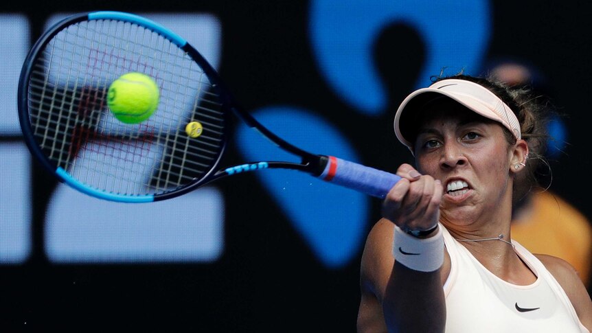 Madison Keys watches the ball as she hits a forehand against Ana Bogdan at the Australian Open.