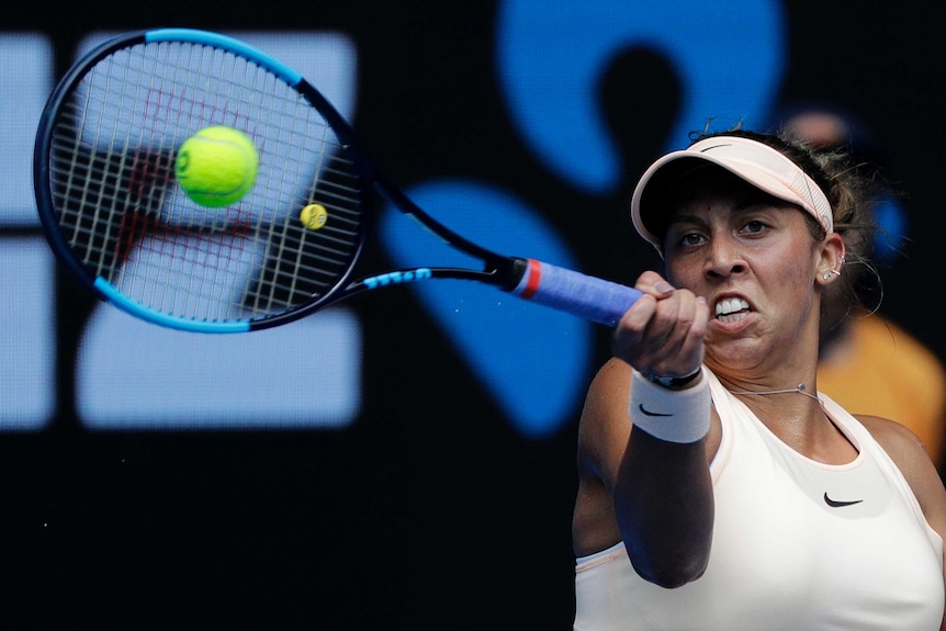 Madison Keys watches the ball as she hits a forehand against Ana Bogdan at the Australian Open.