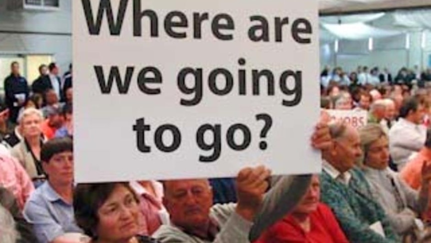 A man holds up a sign during a protest meeting in Griffith.