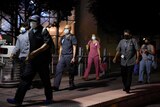 Healthcare workers walk through the Texas Medical Center wearing masks.