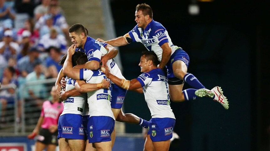 Bulldogs players celebrate a try against Cronulla