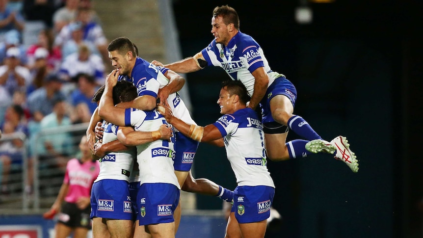 Bulldogs players celebrate a try against Cronulla