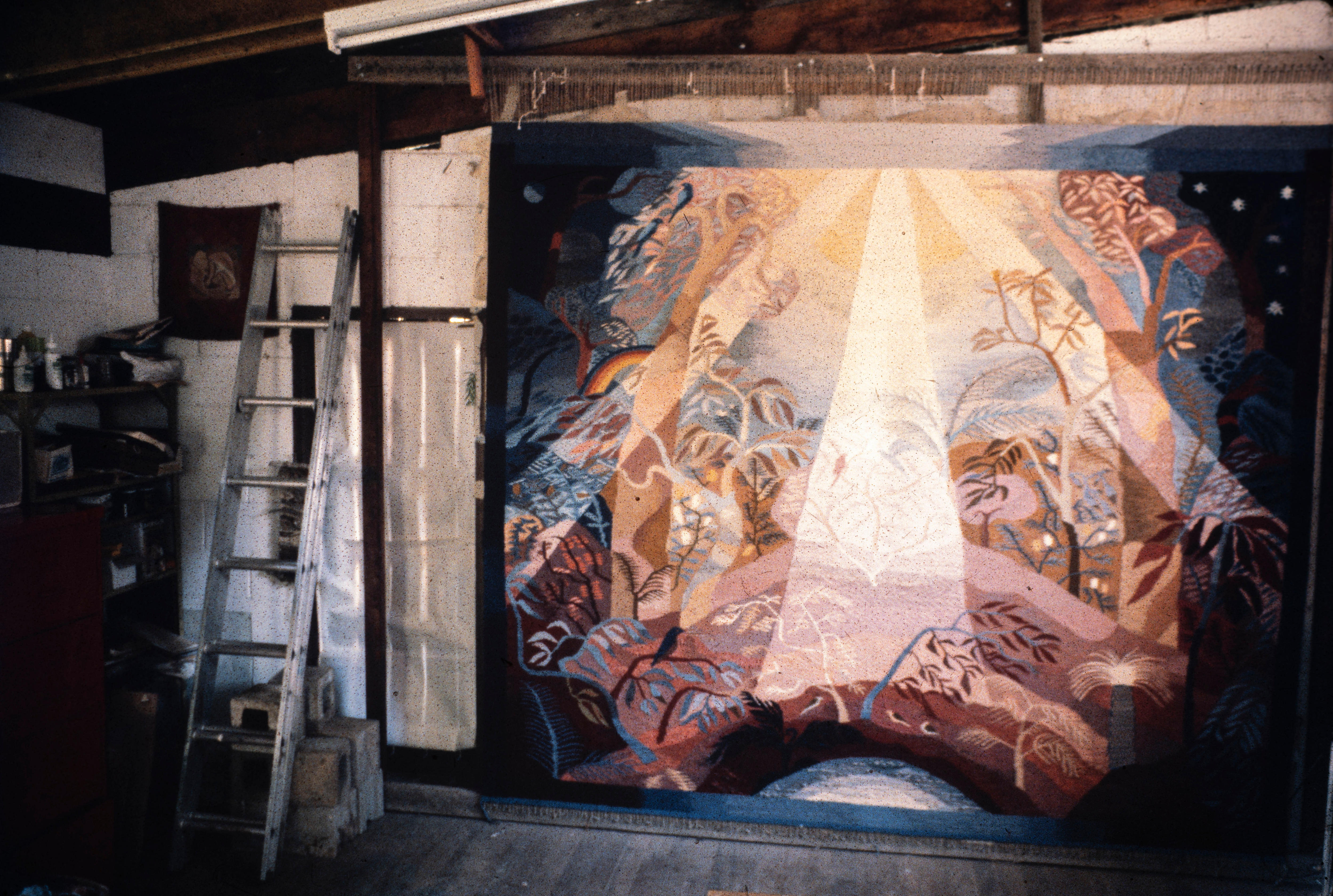 A large wall tapestry hangs in a studio in Bellingen