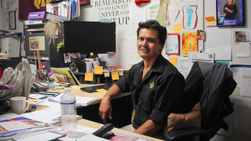 Young People Ahead Manager Alvin Hava sitting at his desk.