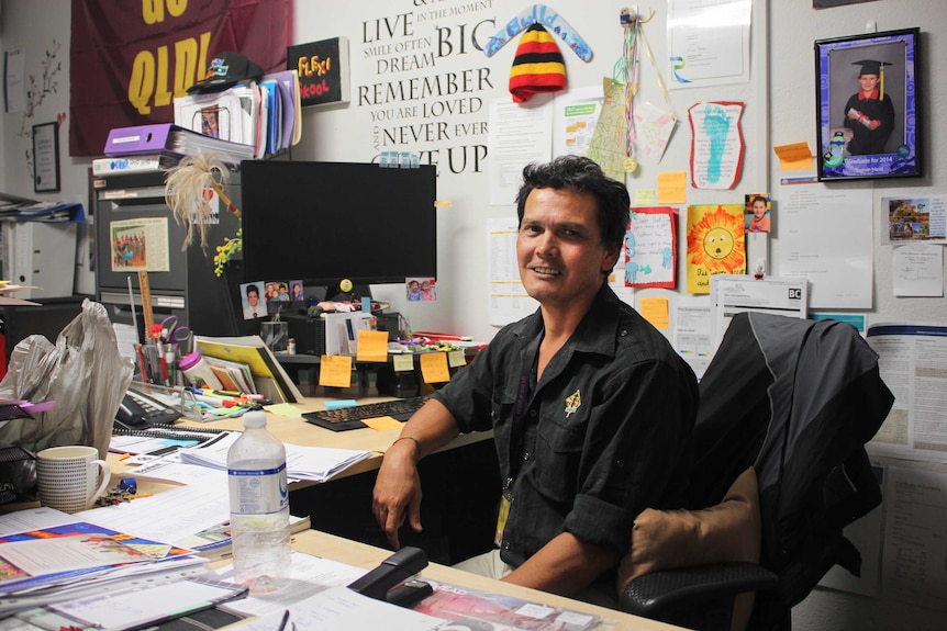 Young People Ahead Manager Alvin Hava sitting at his desk.